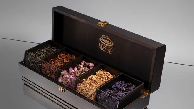 A premium Hosseini Brothers wooden presentation box filled with dried botanicals.